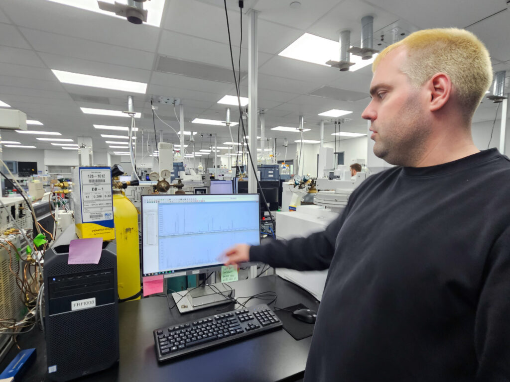 Alex Krotulski points to a computer