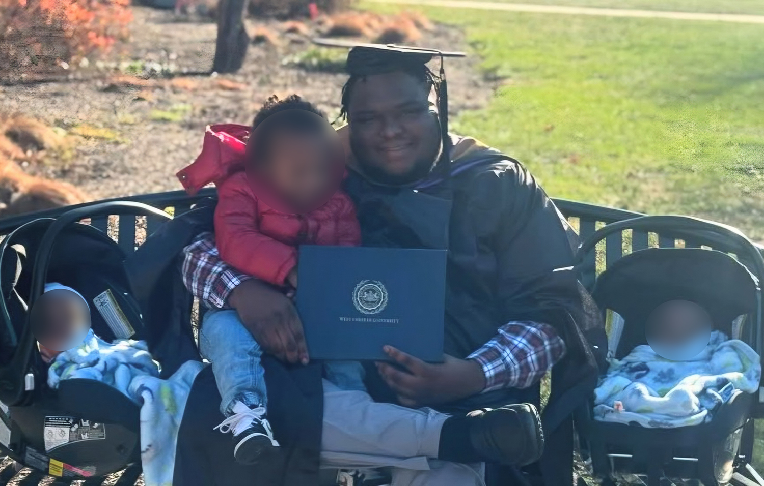 A man celebrates his graduation with his three young children