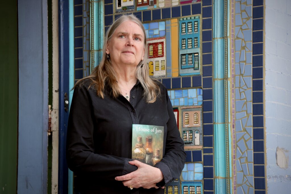 2025 03 19-e lee-alison lewis-philadelphia bindlestiff books-frayed edge press independent publisher 3 Alison Lewis holding her book