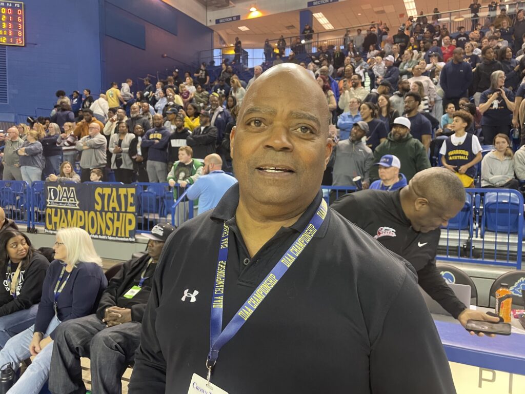 David Baylor posing for a photo at the basketball game