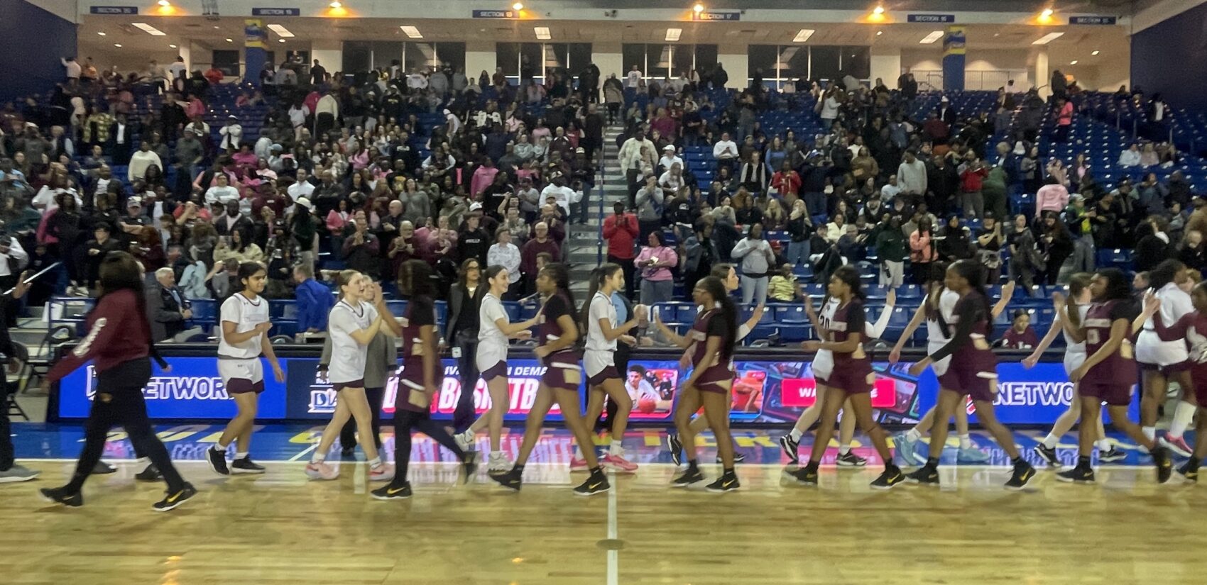 Players from the two teams line up to shake hands after the game