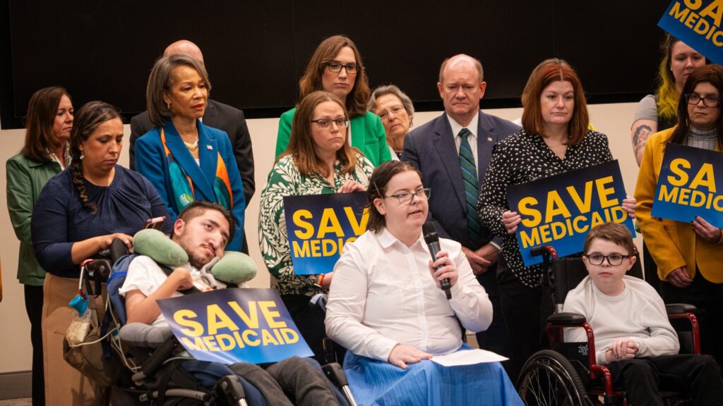 Caroline King speaking into a microphone at the press conference