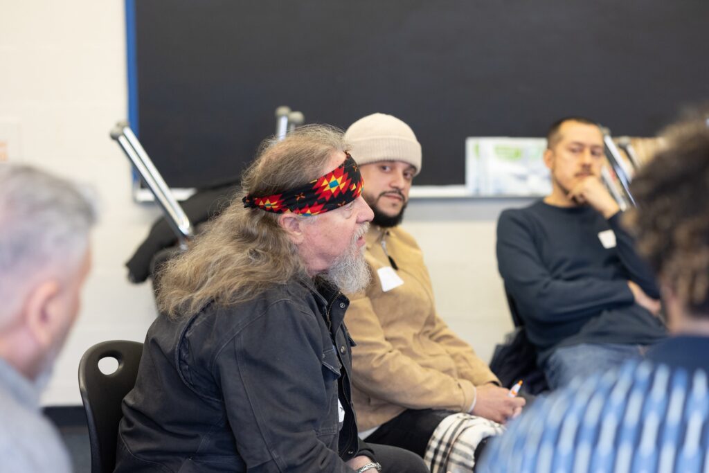 A group of men sitting in a support group