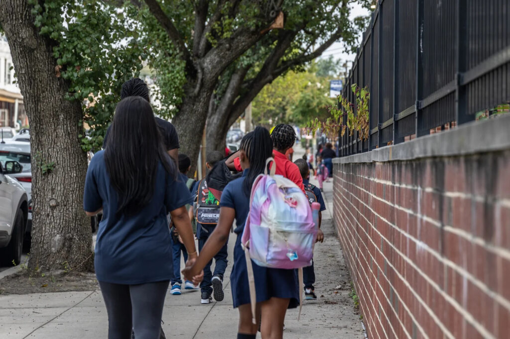 Parents walking their kids kids to Philadelphia's Guion S. Bluford Elementary on the first day of school, September 5, 2023.