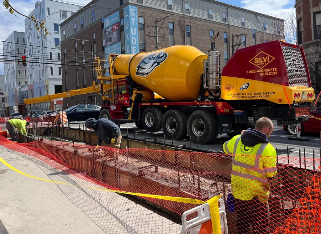 pedestrian-islands-west-philadelphia-construction-2025-1 construction workers and a cement truck at a construction site