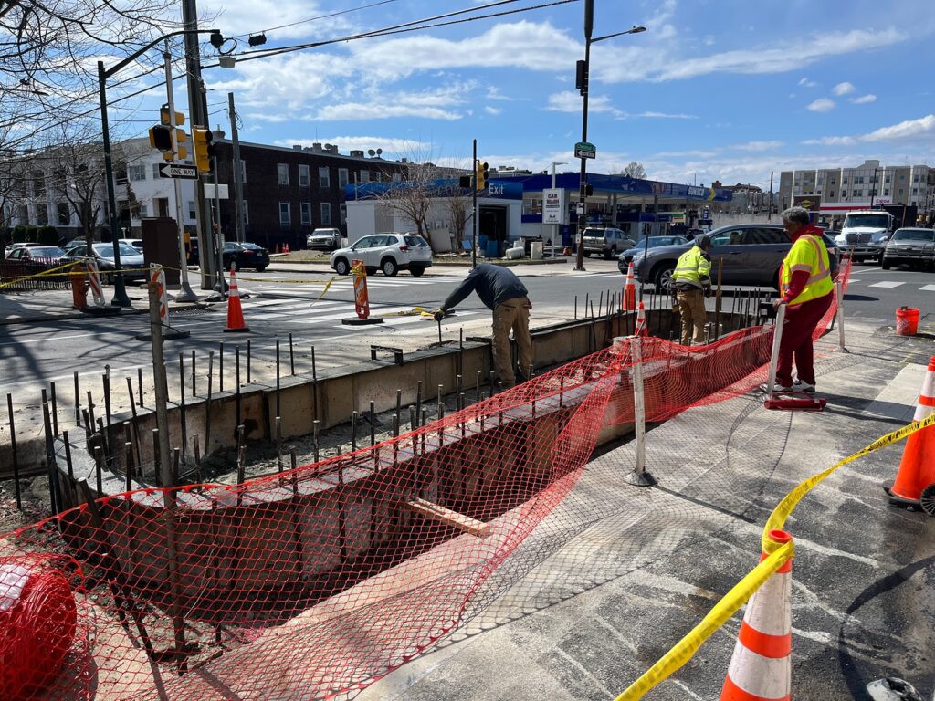 construction workers and a cement truck at a construction site