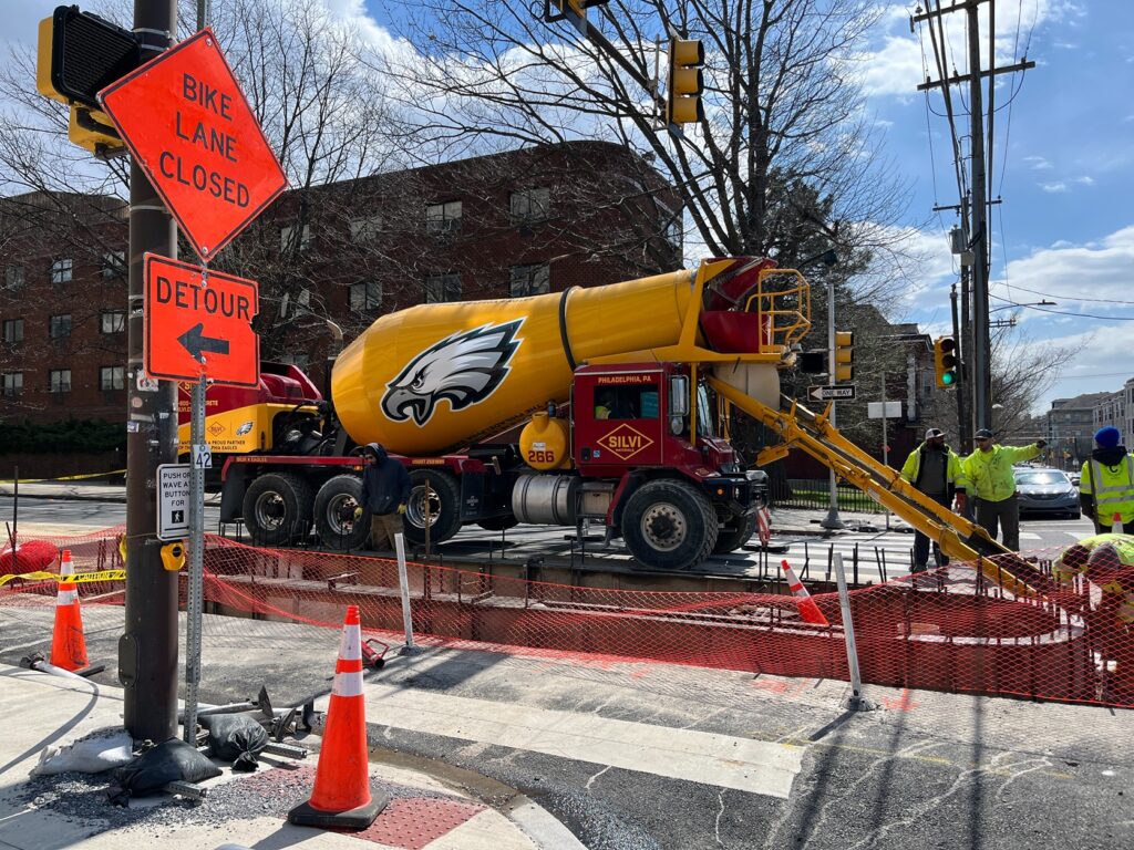 construction workers and a cement truck at a construction site