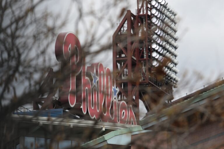 The Phillies sign at the stadium seen through barren tree branches