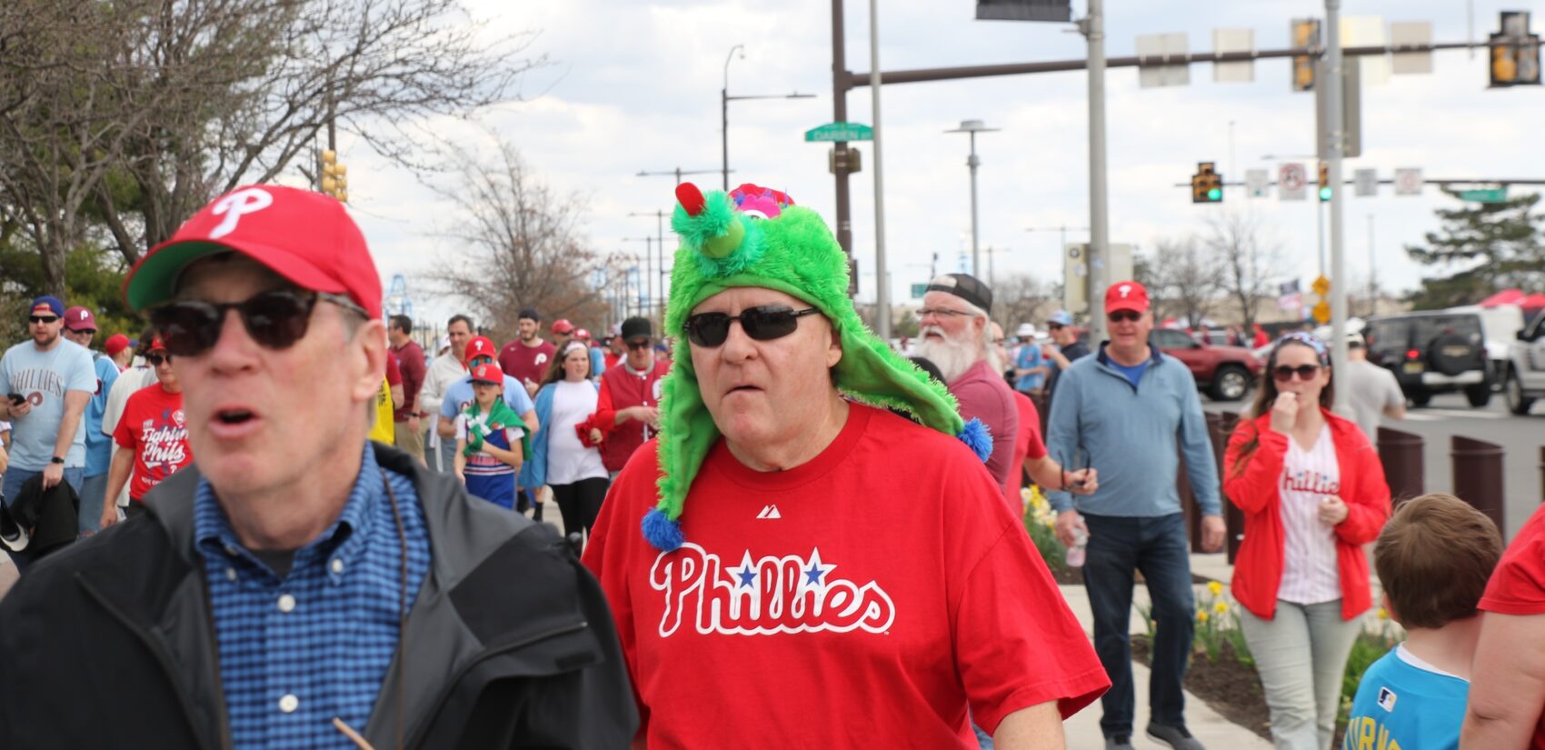 Fans walking into the stadium, one wearing a Phillie Phanatic hat
