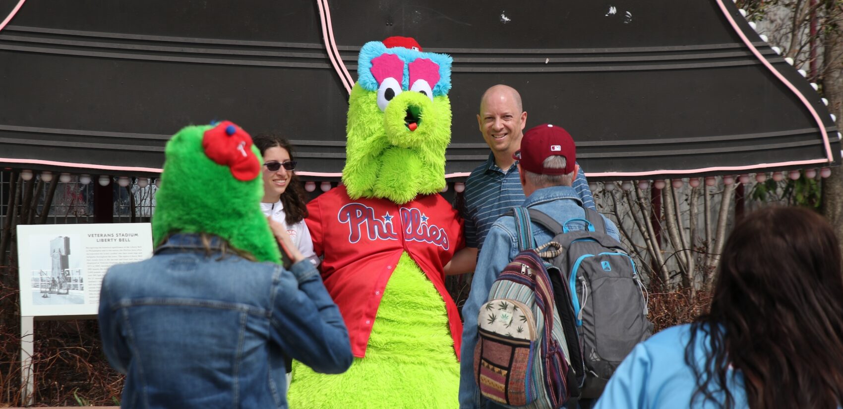 Fans pose for a photo with the Phillie Phanatic