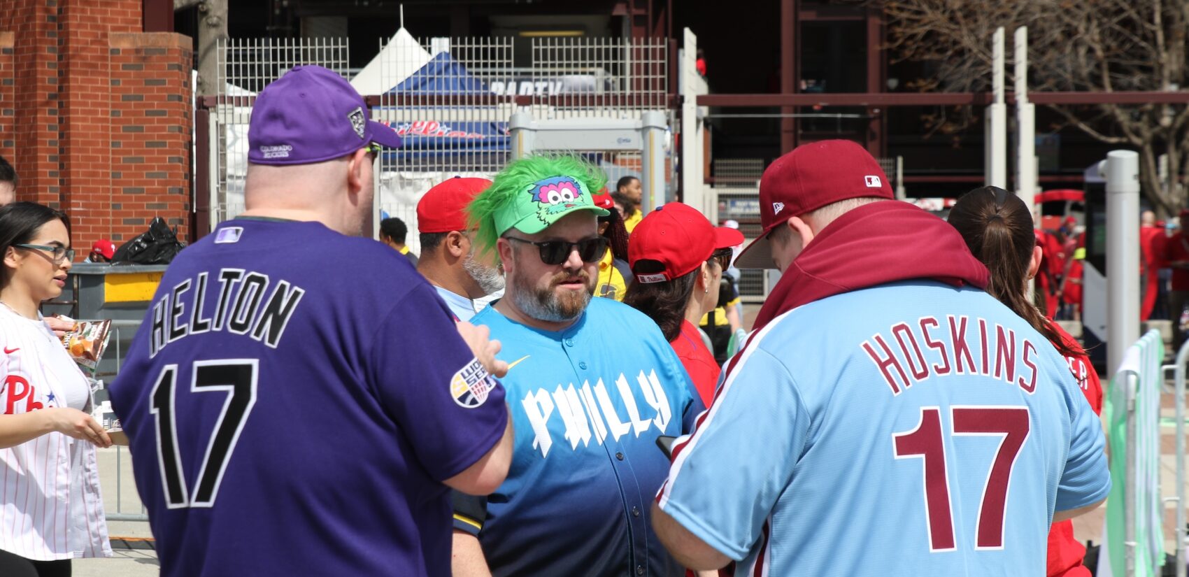 Fans entering the stadium, one wearing a Colorado Rockies shirt