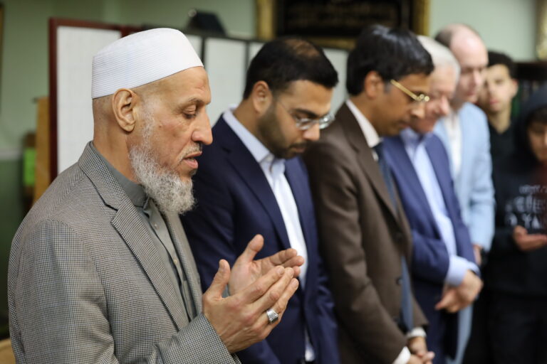 A group of men praying at the mosque