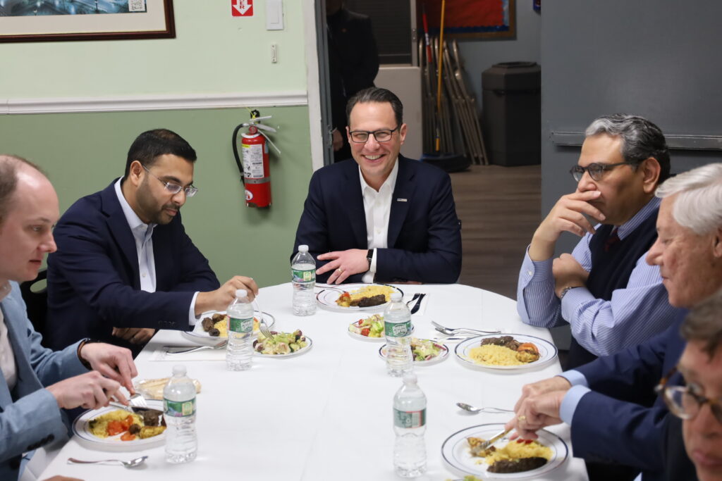 Josh Shapiro and others sitting around a dinner table