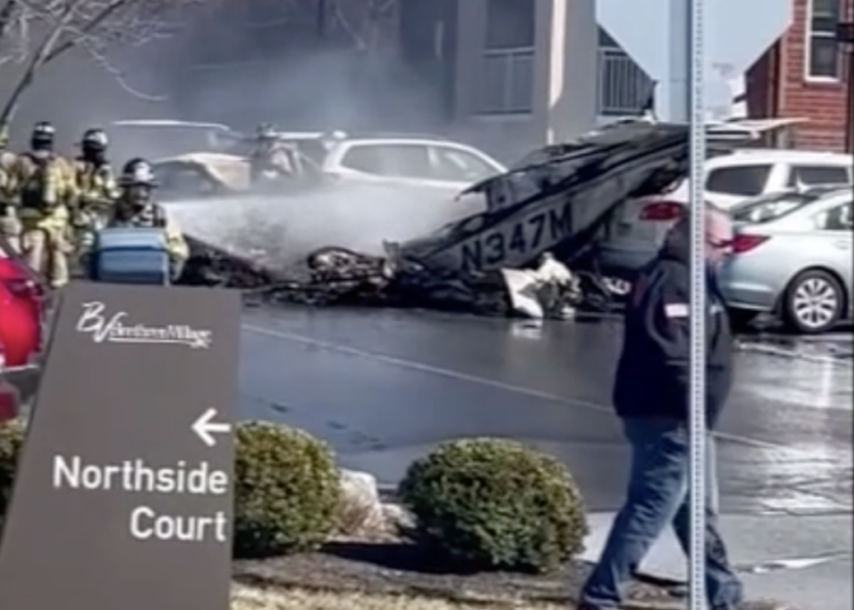first responders spraying water on a small plane crash