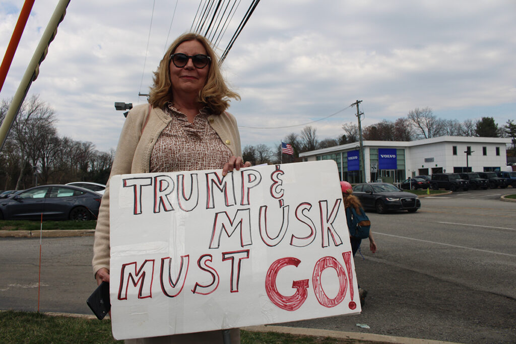 People protest a Tesla car dealership in Chester County