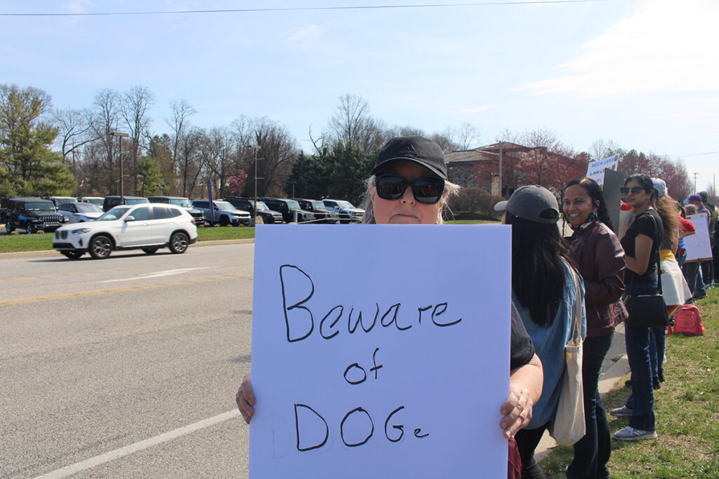 People protest a Tesla car dealership in Chester County