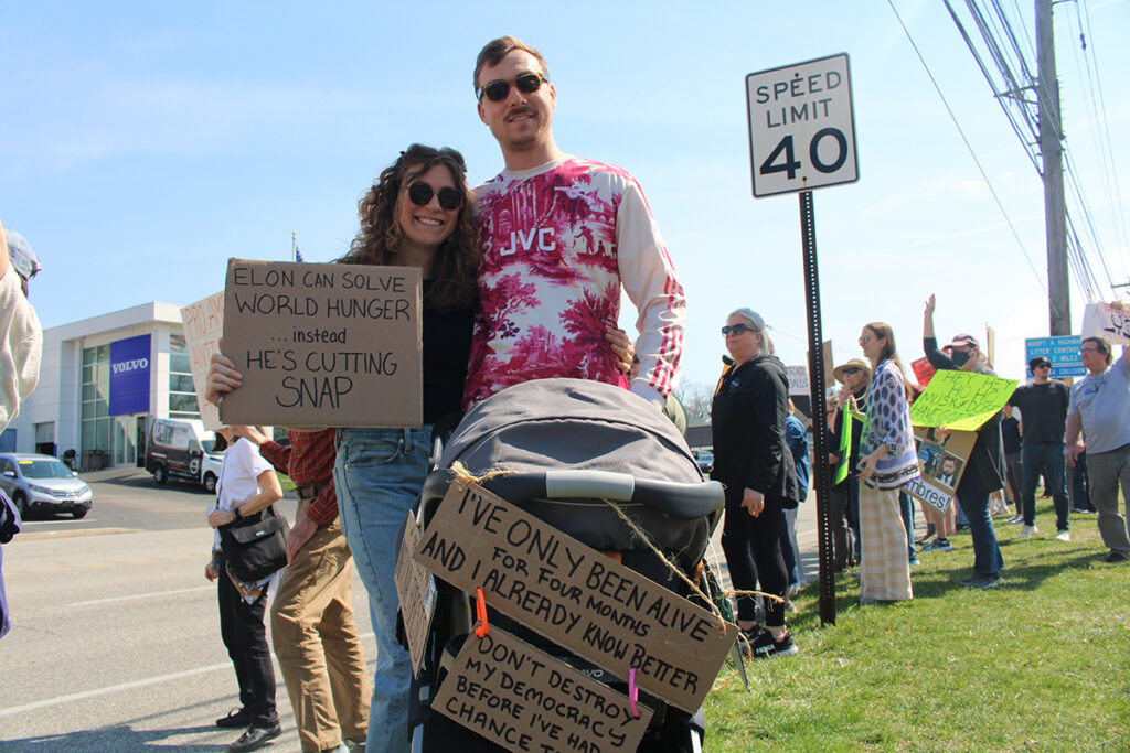People protest a Tesla car dealership in Chester County