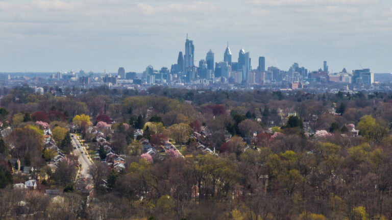 Overhead photo of a residential area, with the Philadelphia skyline in the background