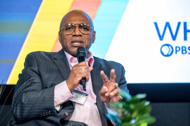 Tony Cuffie speaking on stage during a panel discussion