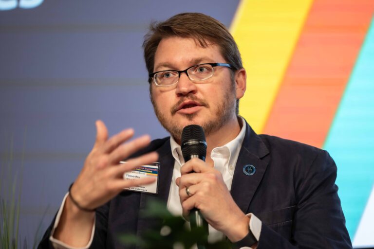 Timothy Shaffer speaking on stage during a panel discussion