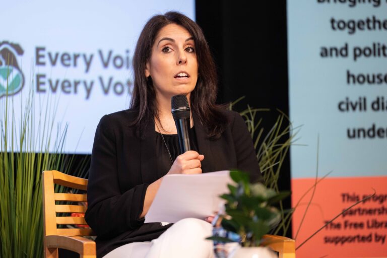 Nina Sachdev speaking on stage during a panel discussion