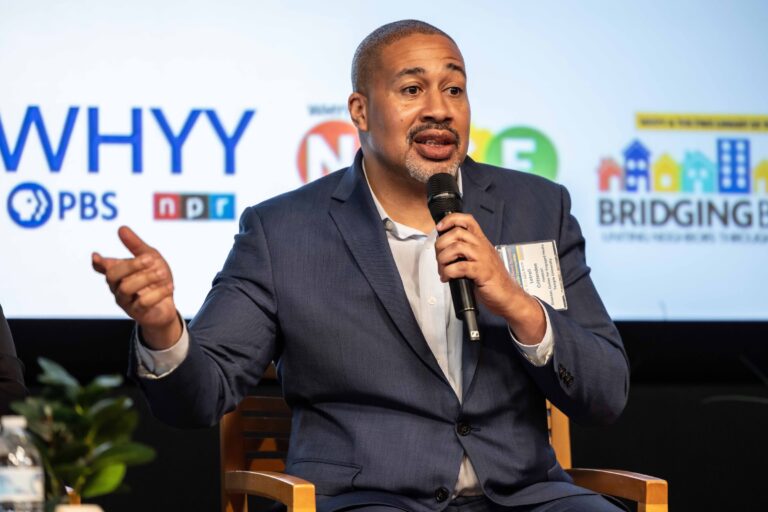 Latrell Crittenden speaking on stage during a panel discussion