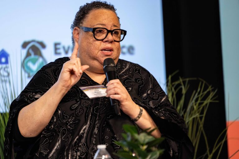 Jamie Brunson speaking on stage during a panel discussion