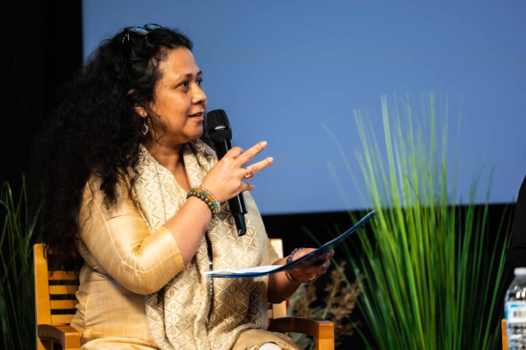 Madhusmita Bora speaking on stage during a panel discussion