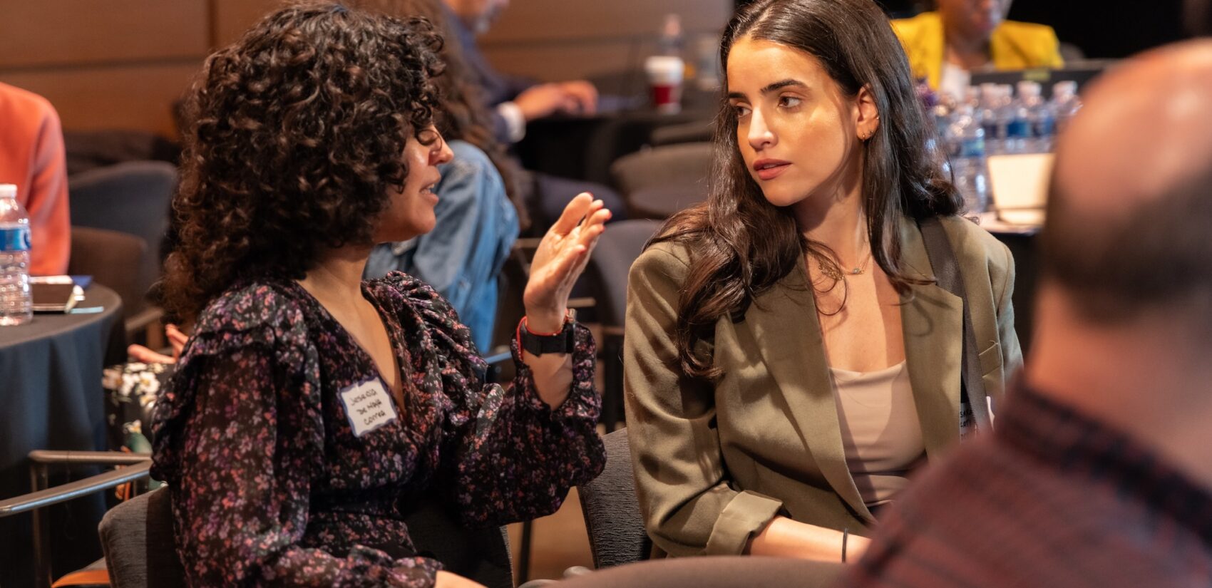 Audience members speaking together at the Summit