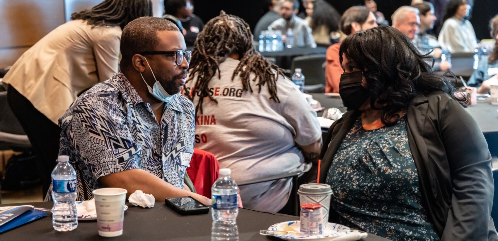 Audience members speaking together at the Summit