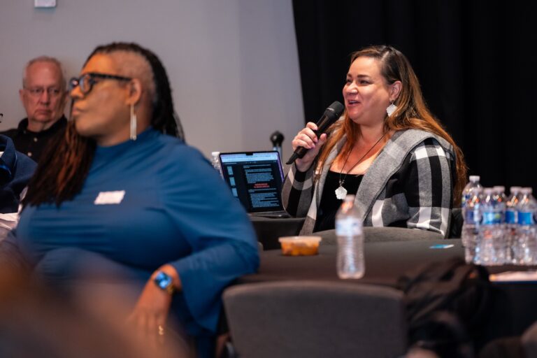 A member of the audience asks a question during the panel discussion