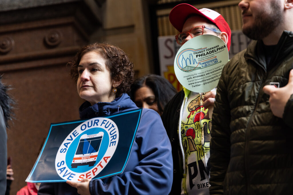 04-11-2025-SEPTA-rally-Philadelphia-3 protesters hold signs, one reading SAVE OUR FUTURE SAVE SEPTA