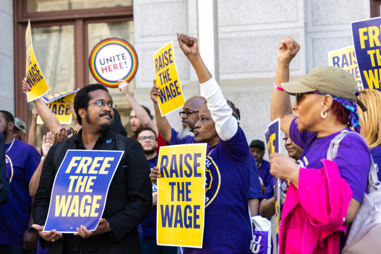 Union members at the rally holding signs saying 