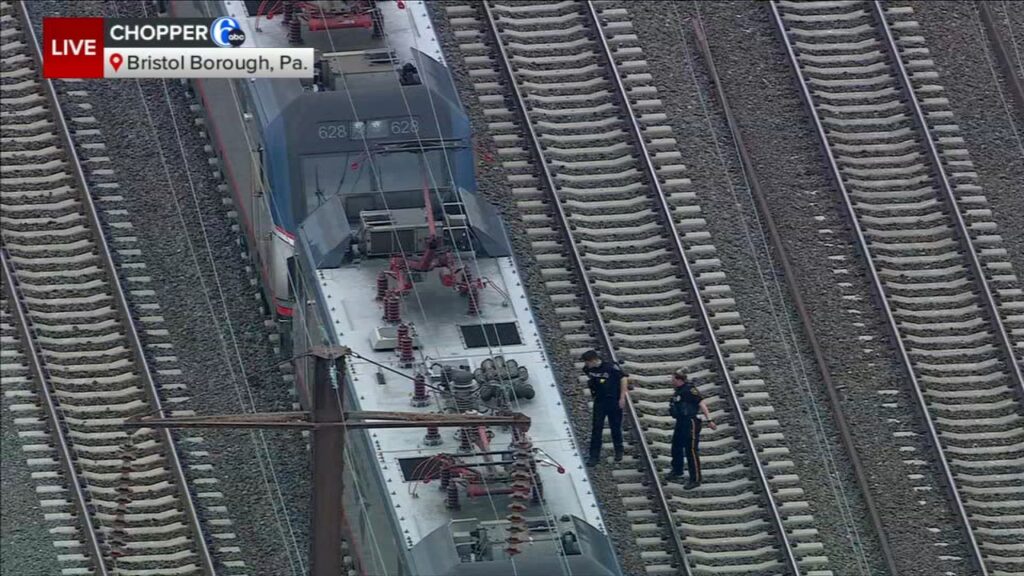 16124394_040325-wpvi-bristol-train-ped-ac-630-CC-vid Police officers inspect an Amtrak train after a crash left at least one person dead