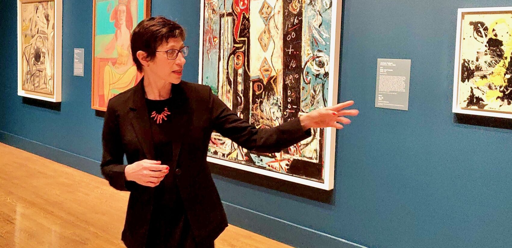 Jessica Smith points to a painting