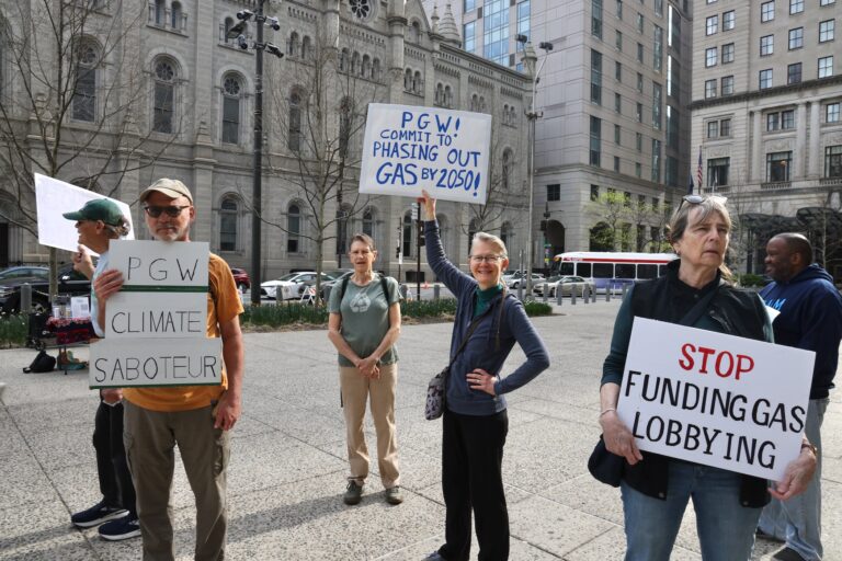 Activists hold signs reading PGW CLIMATE SABOTEUR, PGW! COMMIT TO PHASING OUT GAS BY 2050! and STOP FUNDING GAS LOBBYING