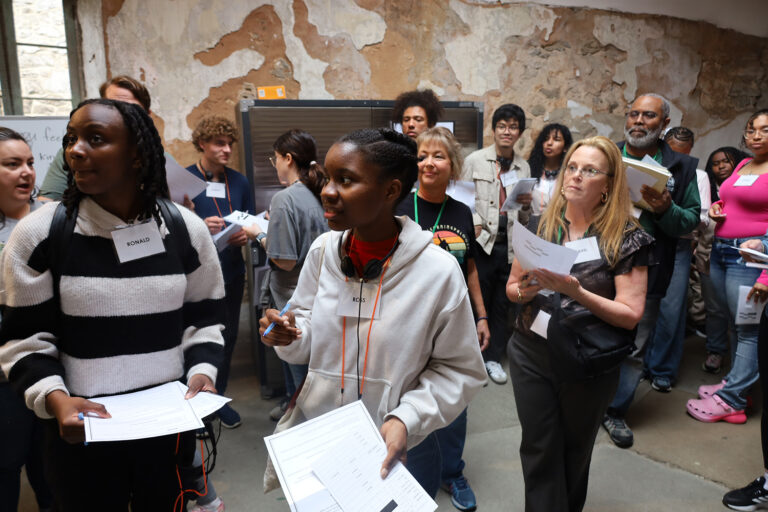 Attendees navigate different tasks during the Eastern State Penitentiary’s Reentry Simulation