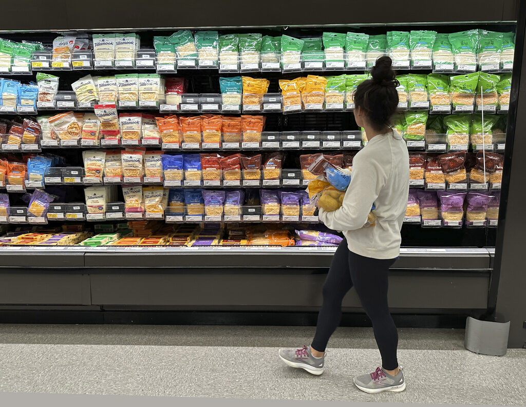 Be Well Financial Wellness Grocery Budgeting A shopper peruses cheese offerings at a Target store in Sheridan, Colo. (AP Photo/David Zalubowski, File)