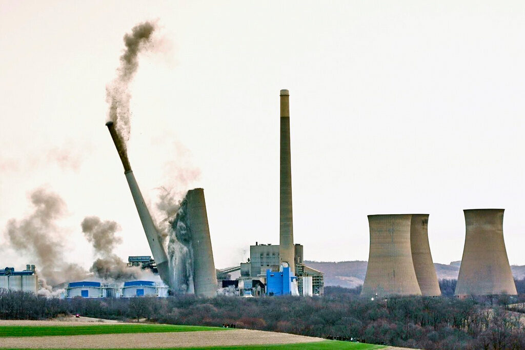 The smokestacks of the former coal-fired Homer City Generating Station crumble in a planned demolition