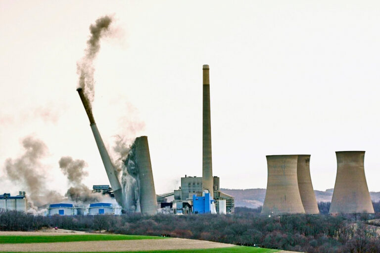 The smokestacks of the former coal-fired Homer City Generating Station crumble in a planned demolition