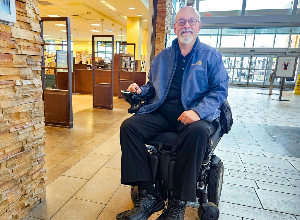 John Nanni posing for a photo in his wheelchair