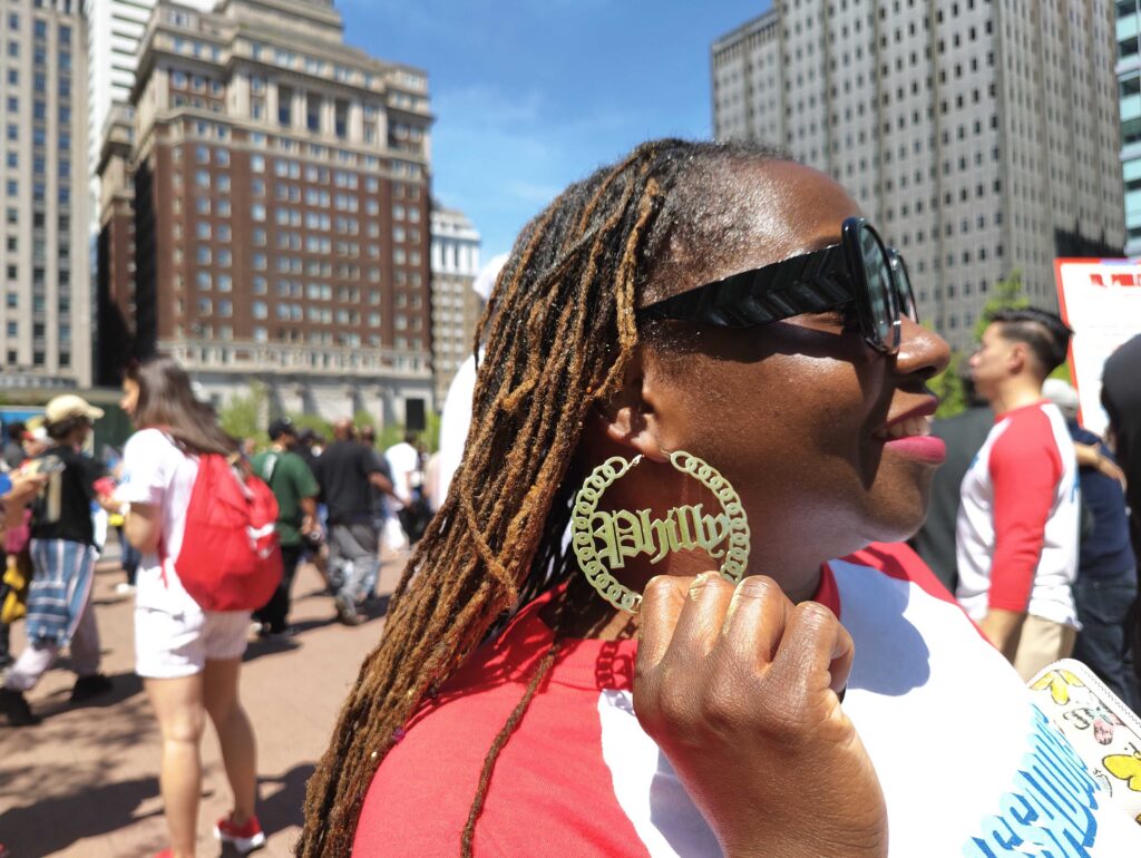 LOVE-Park-rally-philadelphia-volunteers-semiquincentennial-2025-04-29-3 Tiphanie White shows off Philly earrings at the pep rally about volunteering in Philly for the semiquincentennial