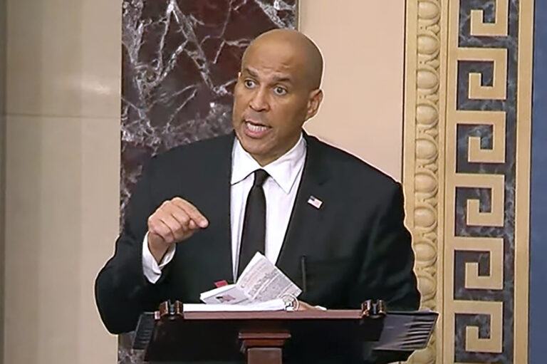 Cory Booker speaking at a podium