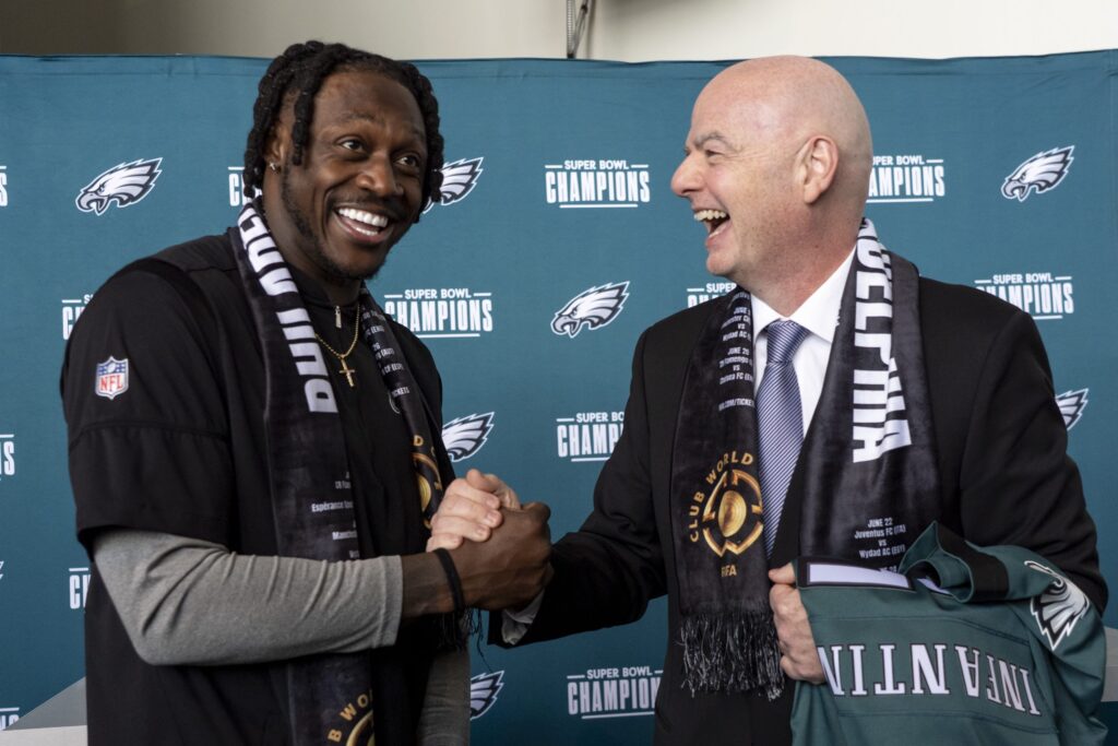 Gianni Infantino and A.J. Brown shaking hands at the press conference