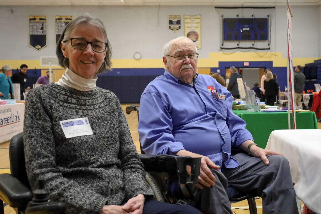 Carol Ferguson (left) and Jim Smith pose for a photo at a Post Polio Network event