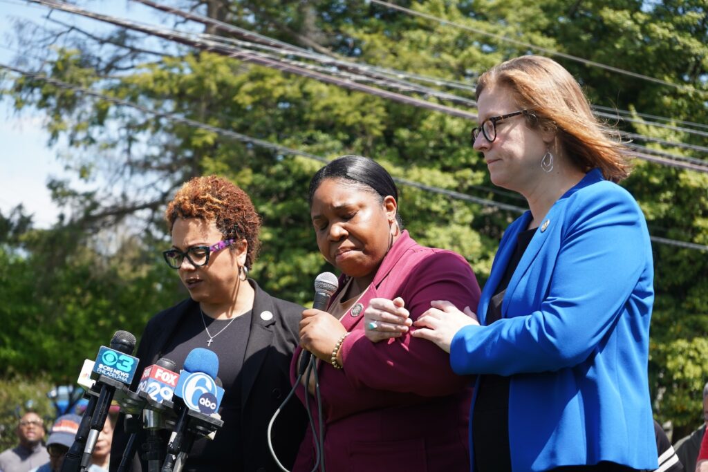 State Reps. Gina H. Curry, Carol Kazeem and Leanne Krueger lead a moment of prayer outside of Crozer-Chester Medical Center