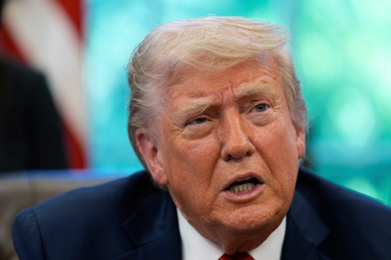 Donald Trump speaks with reporters