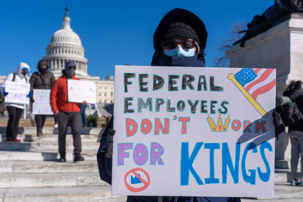 fired-federal-worker-dc-2025-02-17 A masked federal employee protesting