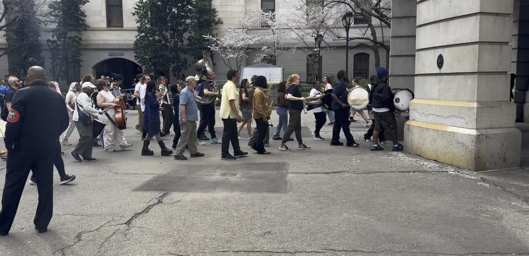 people marching out of the City Hall courtyard at the event