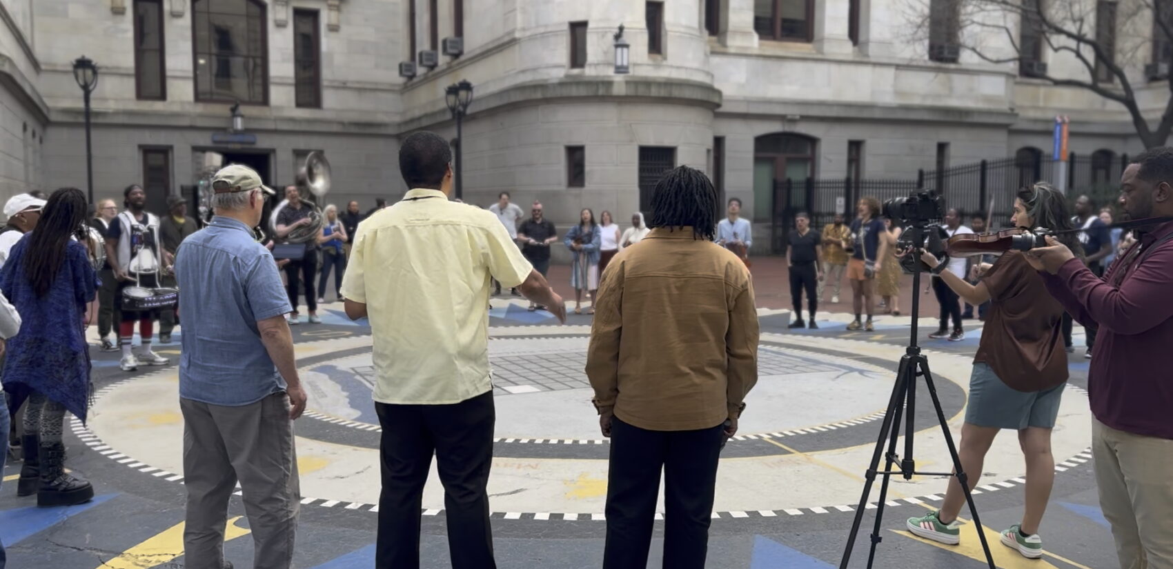 people in a circle at the event in the City Hall courtyard